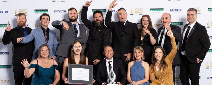 EAS Waikato team celebrating on stage at a business awards ceremony